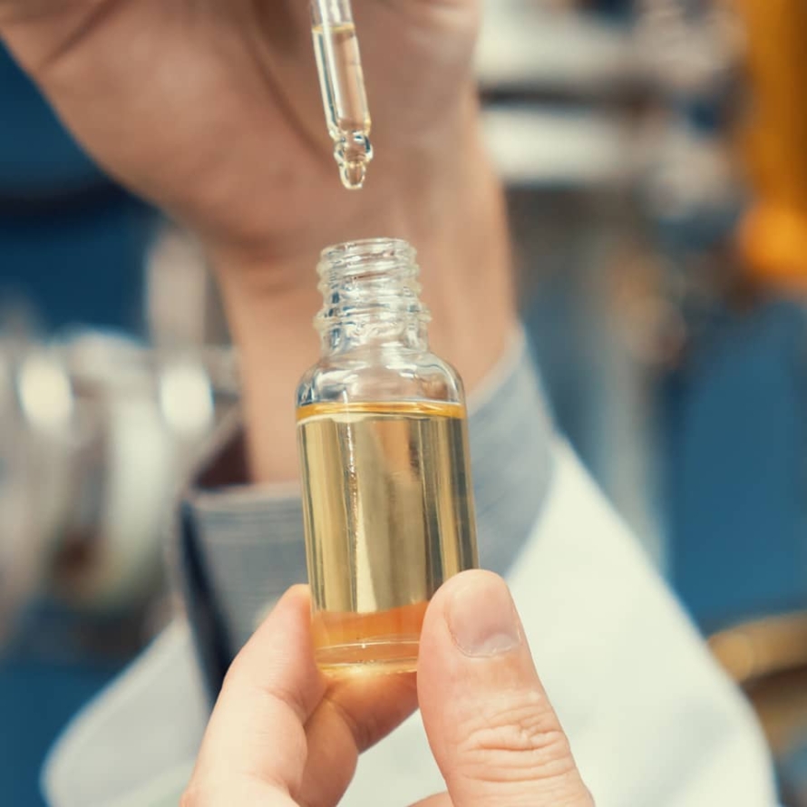 A scientist extracts CBD hemp oil for medicinal purposes in a laboratory.